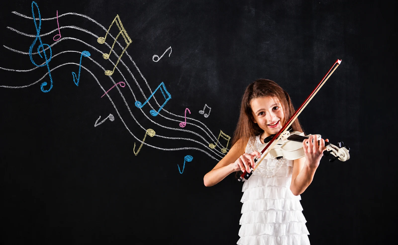 Young child learning violin at Opus 1 Music Studio